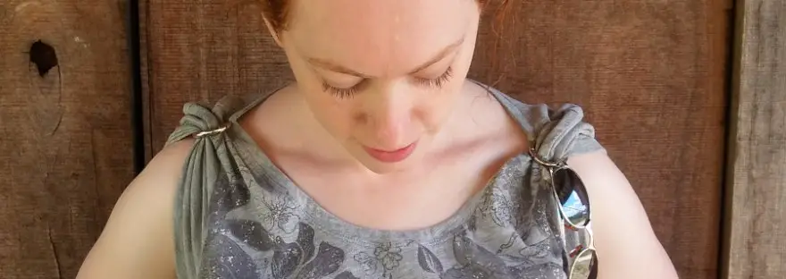 redhaired lady in sleeveless shirt with text overlay: what's the best deodorant for eczema sufferers?